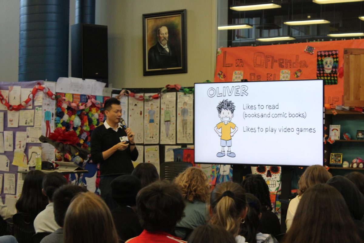 Jorge Cham, the author of Olivers Great Big Universe, introduces the main character Oliver of his graphic novel to Lively students in the Library this morning.