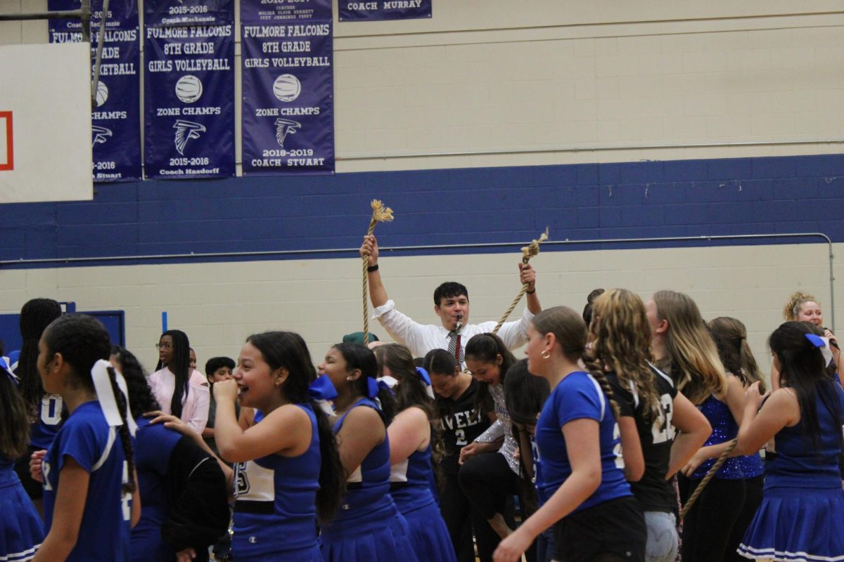 Coach Galan showing the crowd that the tug of war rope snapped in two!