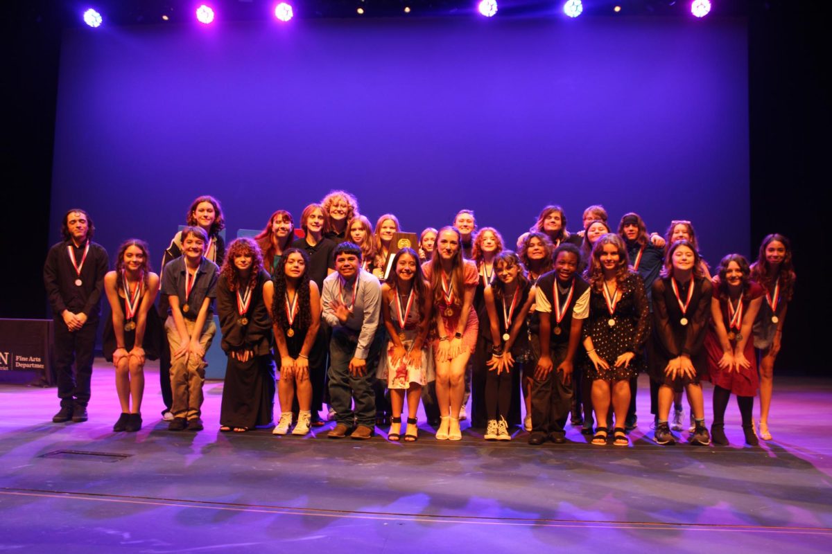 The cast and crew of "The Audition" accepting their plaque and gold medals for winning the district championship.  They had serious competition with Bailey Middle School, Covington Middle School,  Gorzycki Middle School, Kealing Middle School, and Small Middle School.  Bailey Middle School received 2nd place and Gorzycki Middle School received 3rd place.